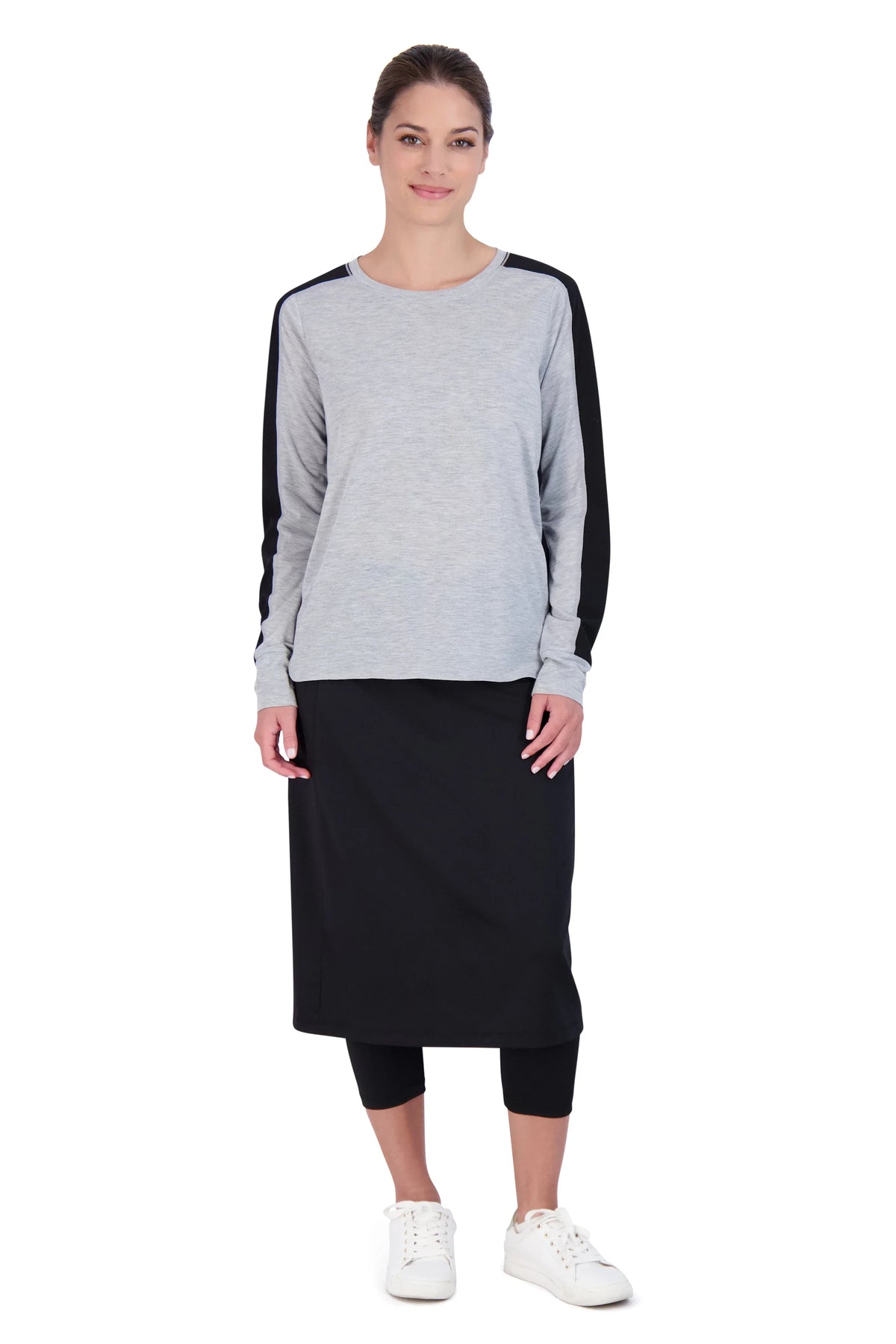 Woman wearing Snoga Athletics black modest skirt with attached leggings, athletic outfit