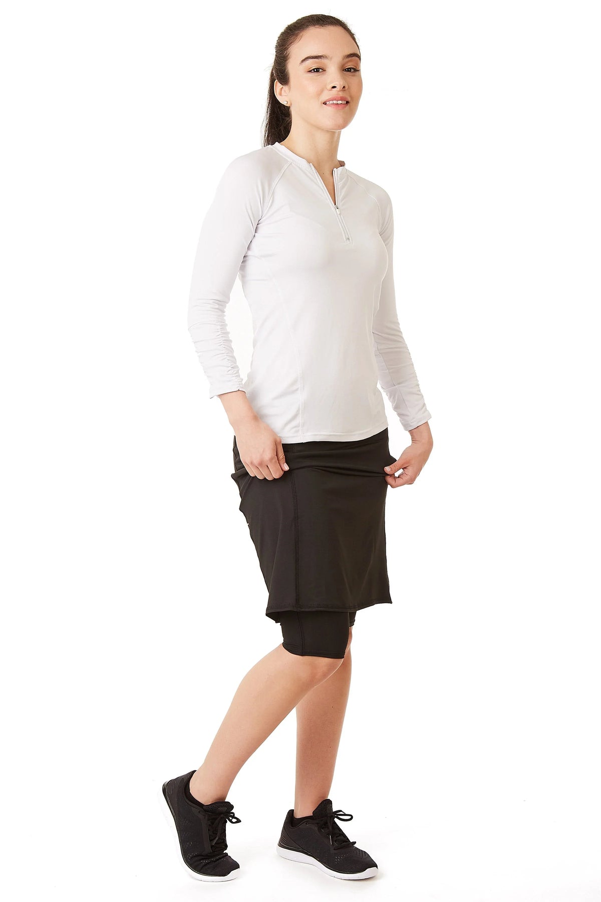 Woman modeling Snoga Athletics black modest skirt with attached shorts and side pocket