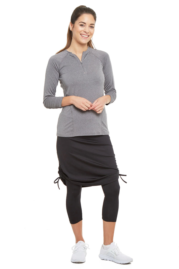 Woman wearing Snoga Athletics black tie-side modest skirt leggings and grey zip top