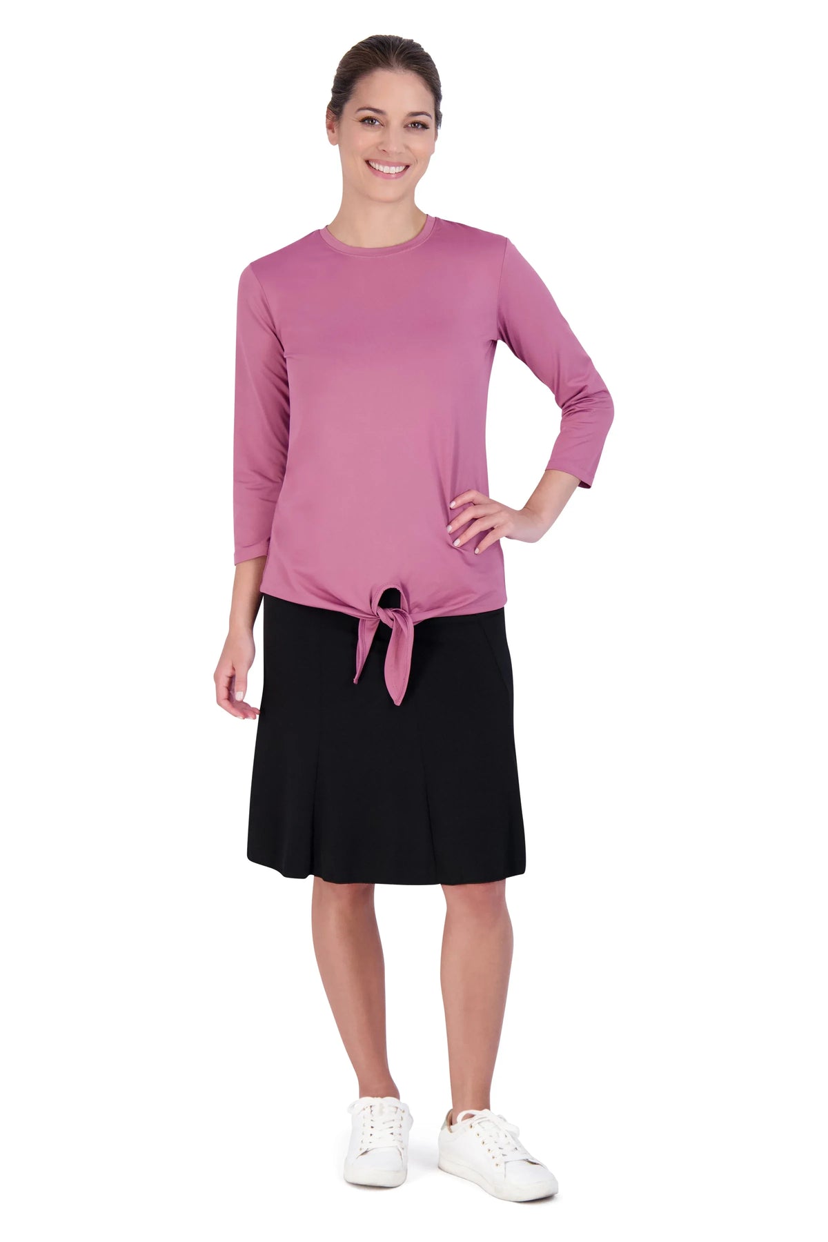 Woman in Snoga Athletics black twirly pull-on skirt and pink tie-front top