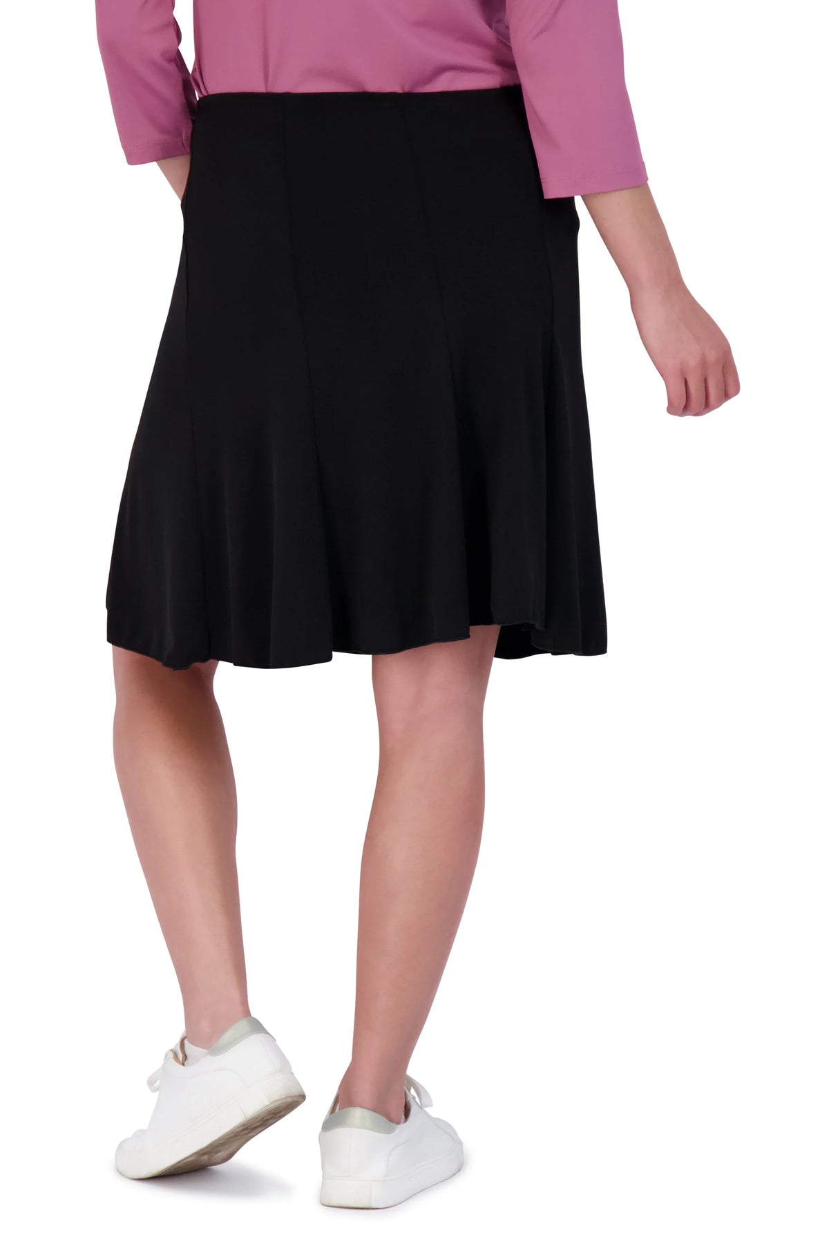 Snoga Athletics black twirly pull-on skirt worn by model with pink top and white sneakers