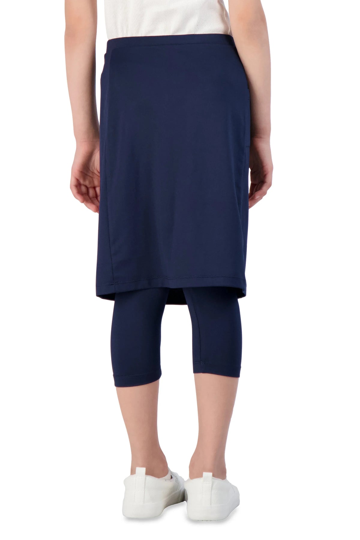 Girl wearing Snoga Athletics navy skirted leggings, white sneakers, modest activewear